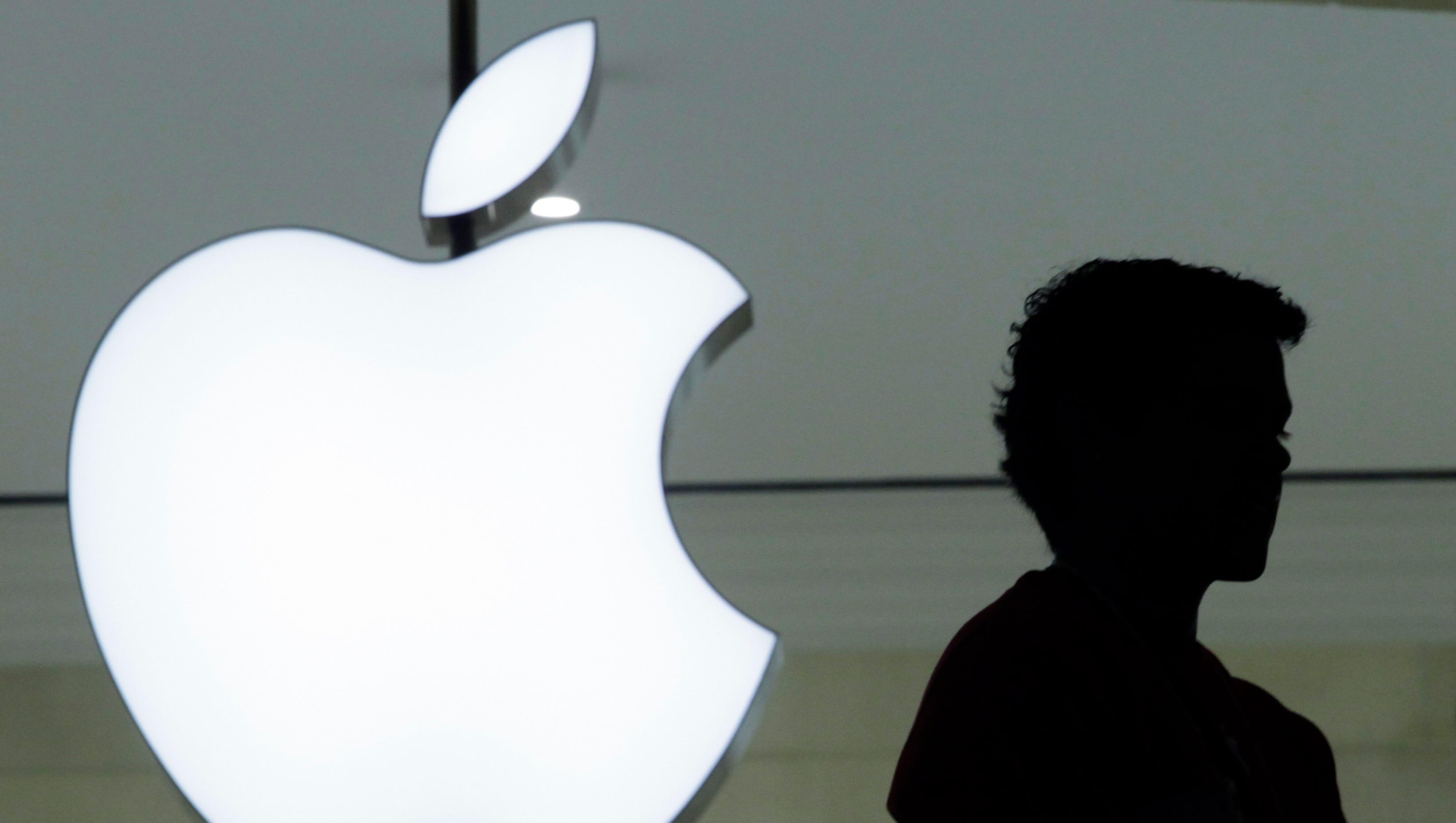 In this Dec. 7, 2011 file photo, a person stands near the Apple logo at the company's store in Grand Central Terminal, in New York.