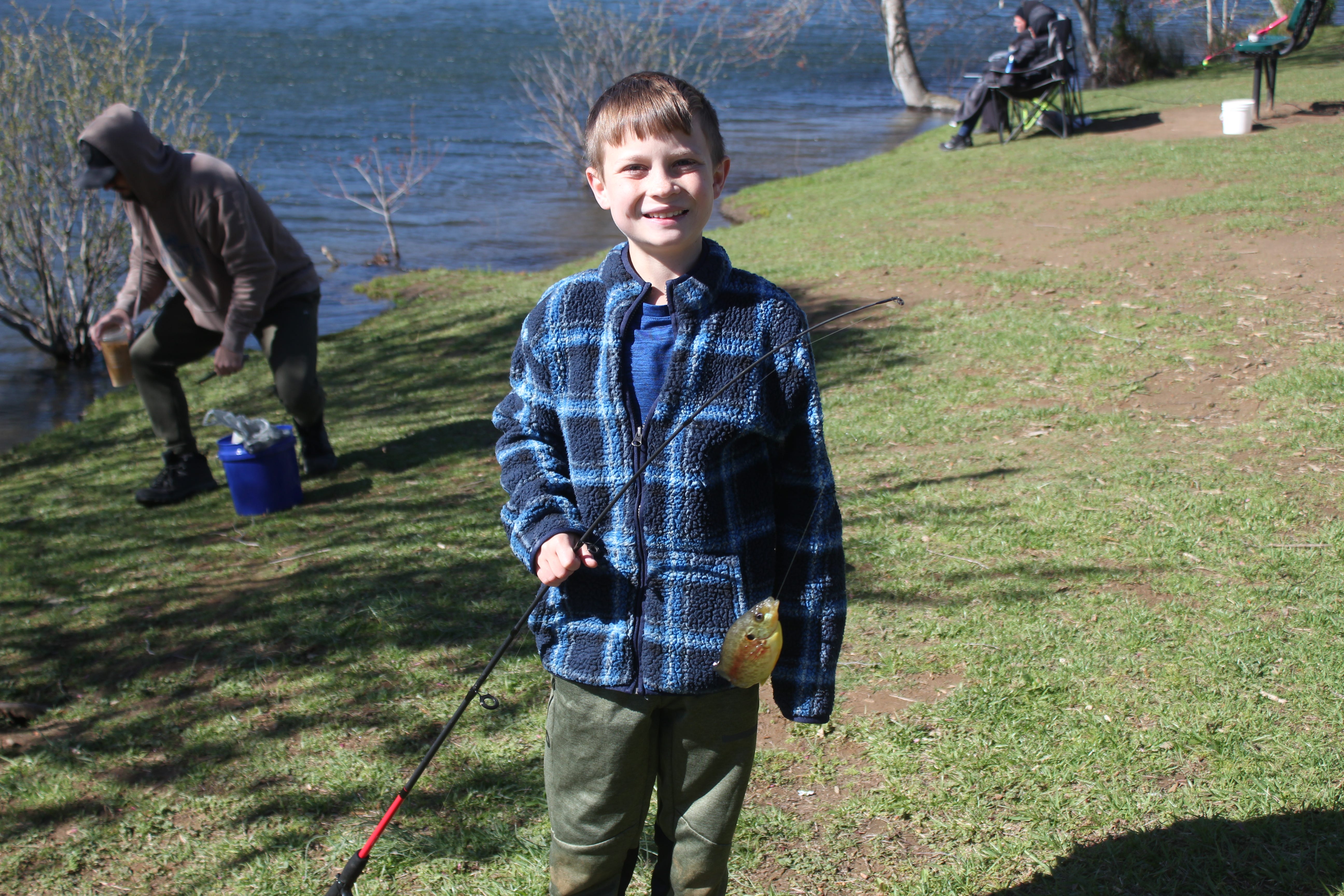 Avery Mackey shows off the fish he caught at Buncombe County Parks and Recreation's kids fishing tournament at Charles D. Owen Park April 13, 2024.
