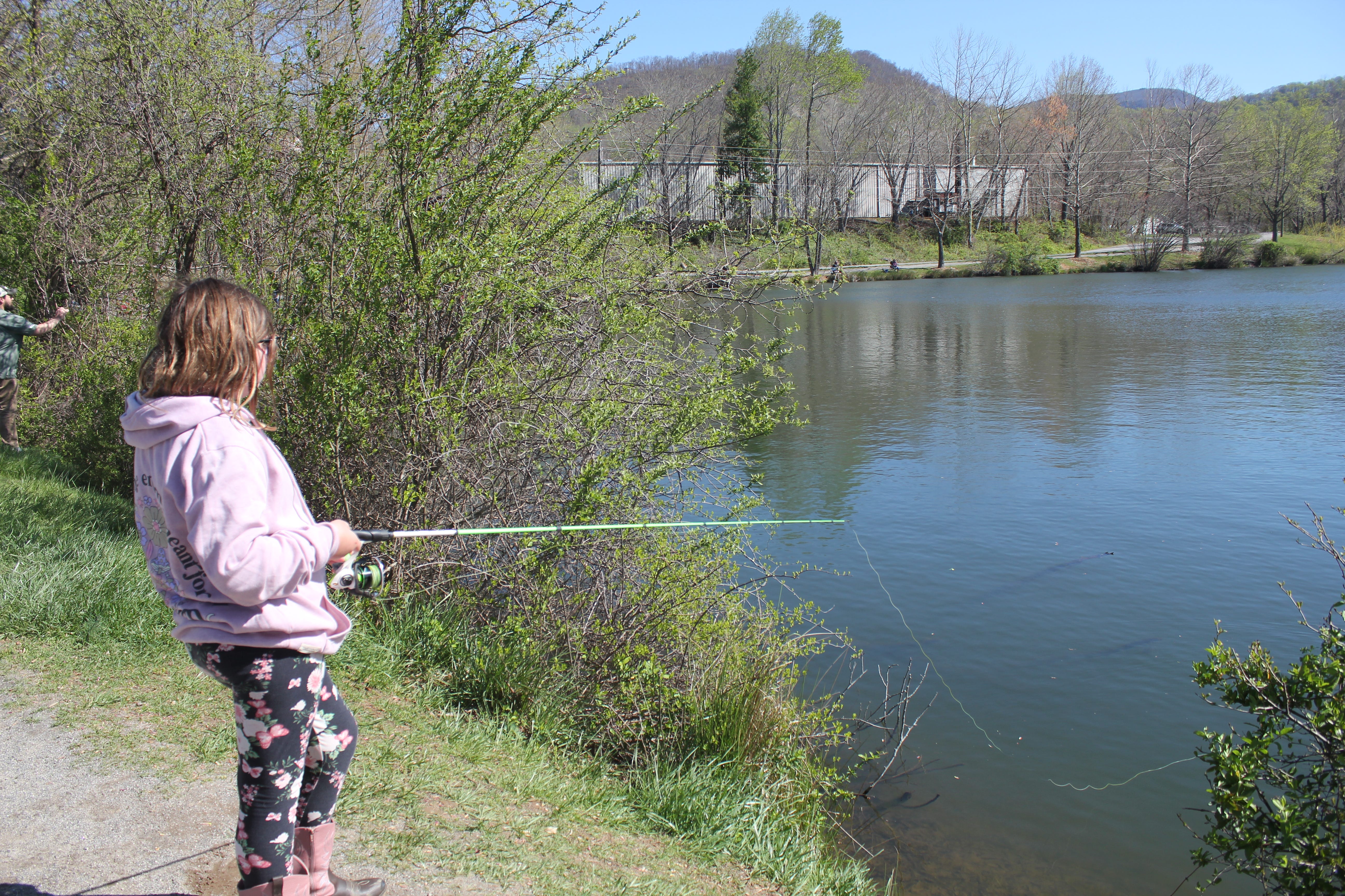Kaylynn Hannigan fishes at Buncombe County Parks and Recreation's kids fishing tournament at Charles D. Owen Park April 13, 2024.